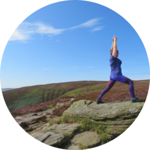 Photograph of Oakwood Yoga Teacher Phillipa Wilson in a yoga post on rocks in the Peak district
